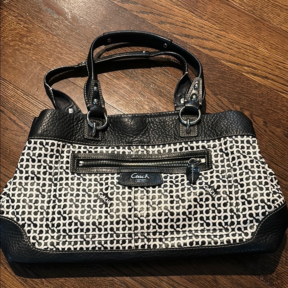Black and white leather coach purse with snap closure